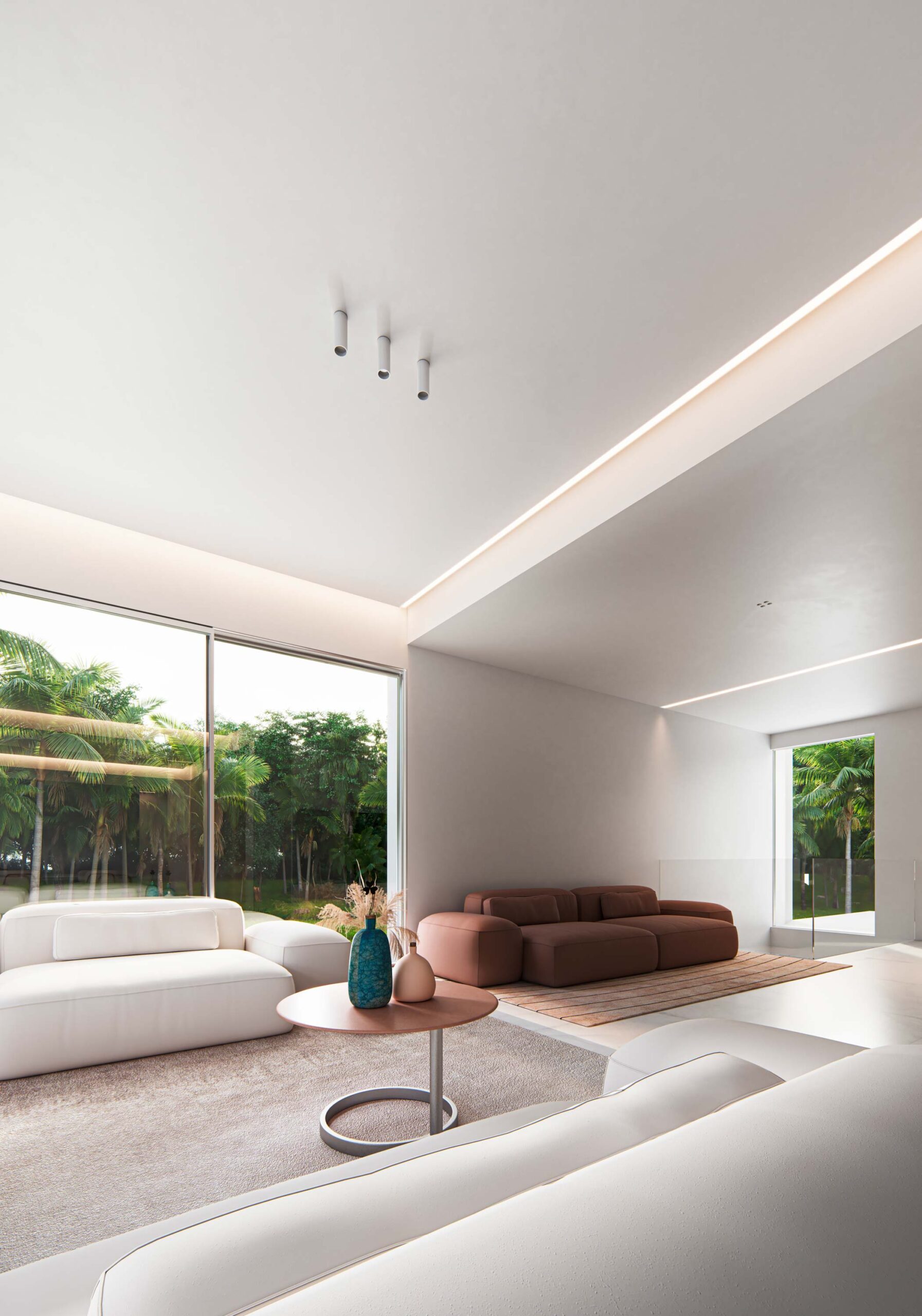 Salón con varios sofás en diferentes tonos y grandes ventanales al jardín proyecto Casa Proa